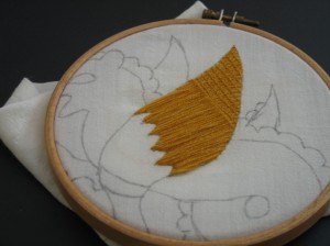 first part of the couched embroidery, the wing is partially completed.